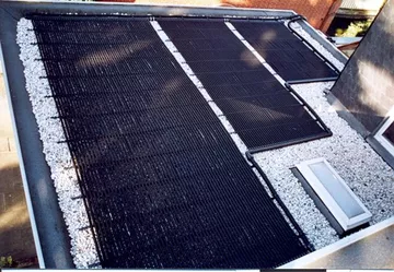 Solar Poolheizung solar-rapid auf dem Dach  neben einem Pool montiert